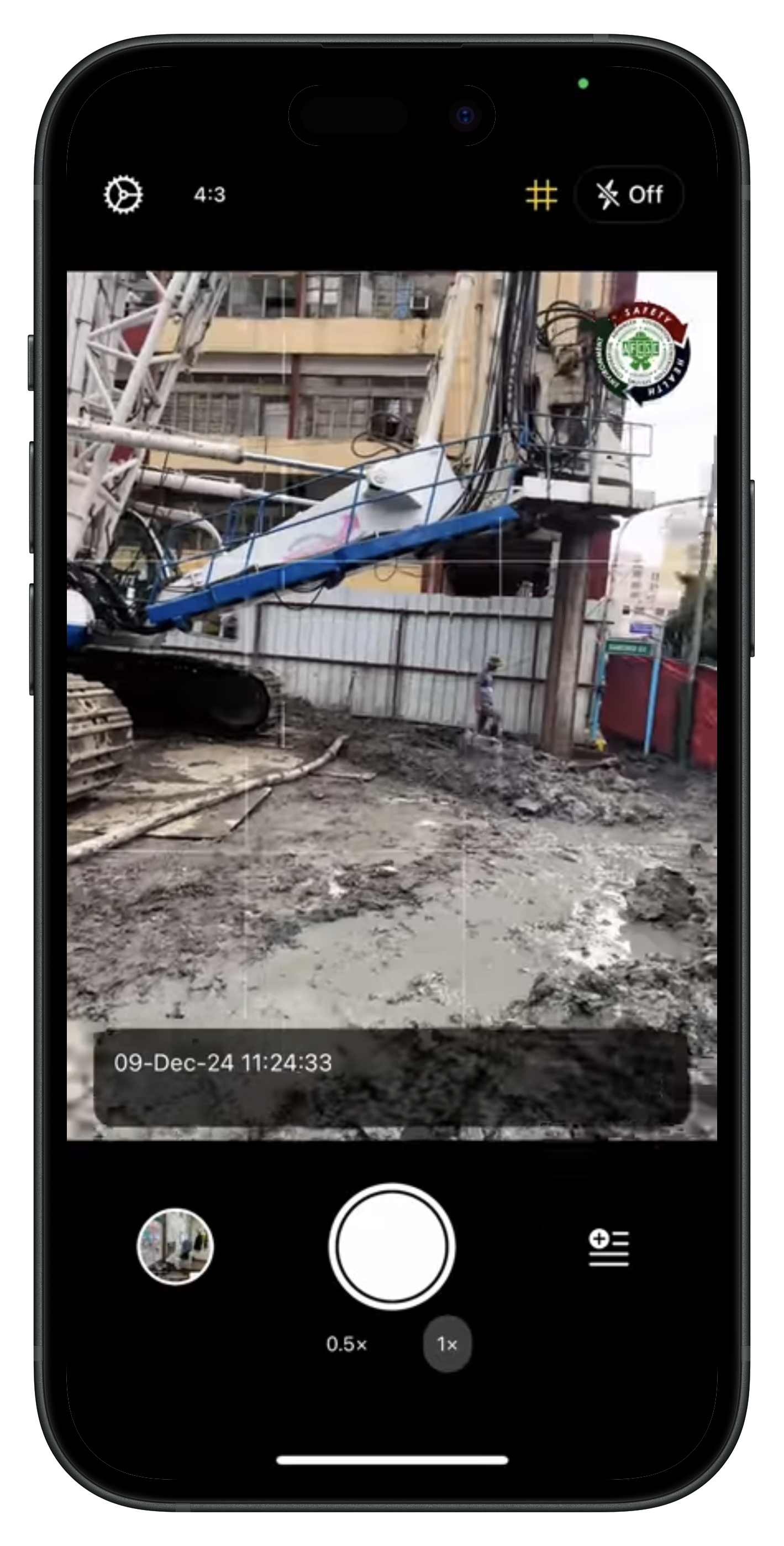 Lens camera on a construction site with timestamp and project overlay on the viewfinder